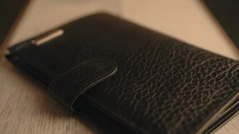 Drops of water splash onto a part of leather wallet. Waterproof and protection Stock Footage 126532584