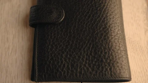 Drops of water splash onto a part of leather wallet. Waterproof and protection Stock Footage 126532647