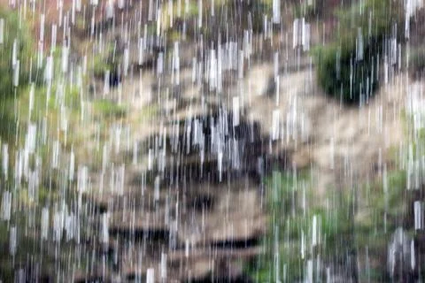Drops of water, splashes of flow from a waterfall or rain fall down Stock Photos