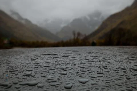 Drops of water on the table after the rain Stock Photos
