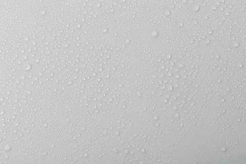 Drops of water on white background create a pattern during rainy weather in.. Stock Photos