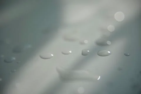 Drops of water on white surface with shadow Stock Photos