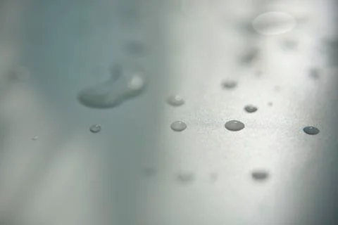 Drops of water on white surface with shadow Stock Photos
