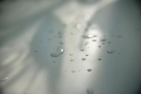 Drops of water on white surface with shadow Stock Photos