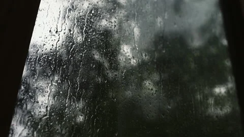 Drops of water on the window. camera movement along wet glass on a rainy day Stock Footage 155689297