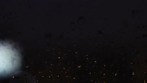 Drops of water on the window slowly flow down the glass at night Video stock 166232846