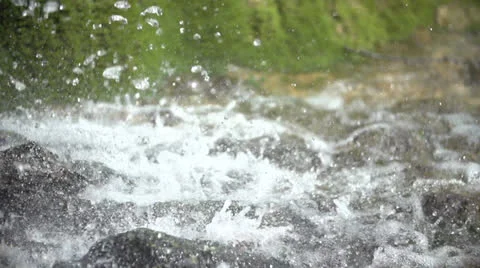 Drops from a waterfall falling on a stone in slow motion (200fps) Stock-Footage 23483948