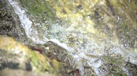 Drops from a waterfall falling on a stone in slow motion (200fps) Stock-Footage 23484017
