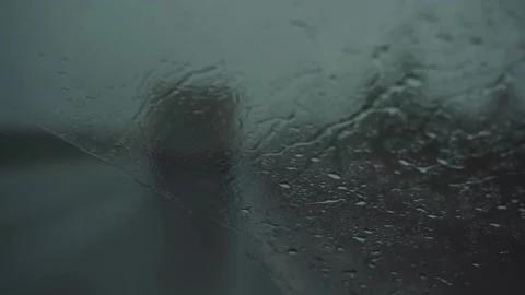 Drops on the windshield view from inside a car. Car driving in the heavy rain Видео 232377310