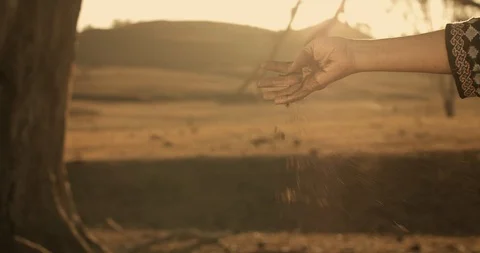 Drought dust sifting through womans hand emptying dirt through fingers on farm 스톡 동영상 122347236