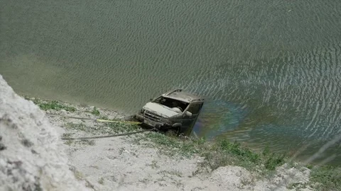 Drowned jeep car is pulled out of the water Video stock 146649249