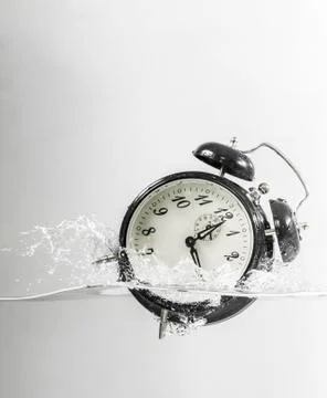 Drowning clock in the water Stock Photos