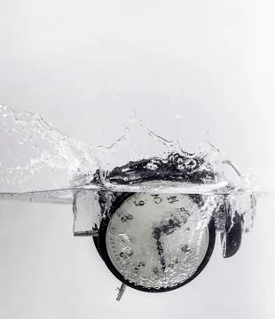 Drowning clock in the water Stock Photos