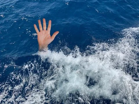 A drowning man asks for help. The hand of a man in the deep sea. Sticking you Stock Photos