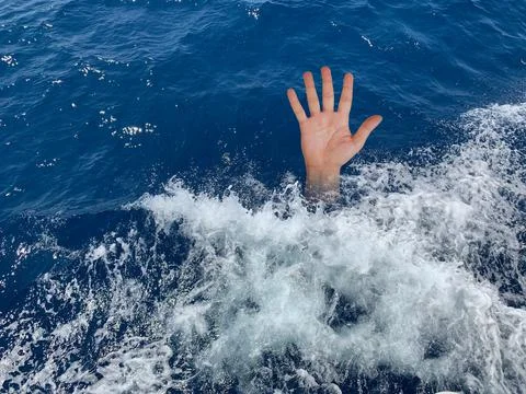 A drowning man asks for help. The hand of a man in the deep sea. Sticking you Stock Photos