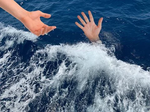 A drowning man asks for help. The hand of a man in the deep sea. Sticking you Stock Photos