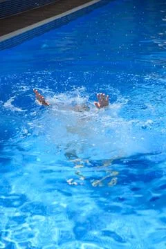 Drowning person hands reaching for help in a swimming pool. Water safety, rescue Фото