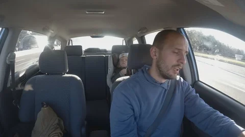 Drowsy Man Driving a Car with baby. Male Driver Falling Asleep. Time laps Stock Footage 106930096