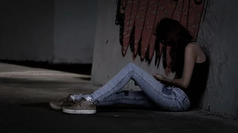 Drug addict girl sits, then falls, dropping syringe, slow motion. Stock Footage