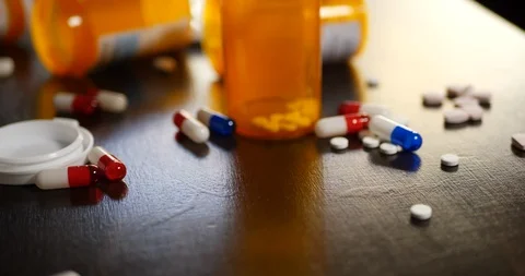 A drug addict grabbing prescription drug pain killers, pills and narcotics Stock Footage