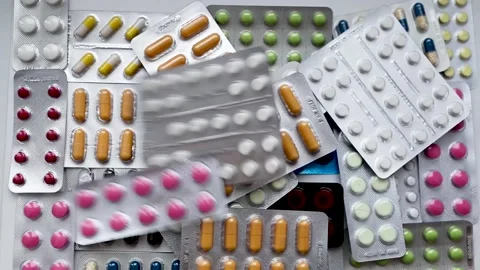 Drug blisters falling on the background of different pill blisters. Stock Footage 135360822