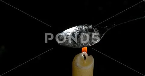 Drug, Cocaine in spoon with Candle against black background Stock Photo ...