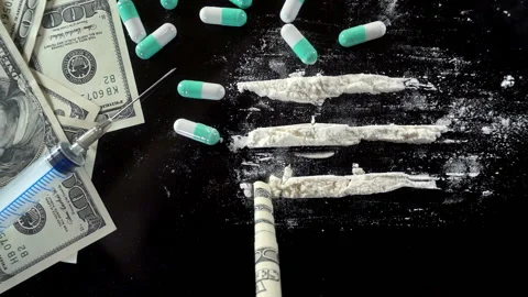 Drug tracks are pulled in with a rolled up dollar bill in slow motion Stock Footage 170724611
