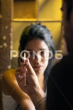 Drugs and people, man helping woman with heroin syringe Stock Photos