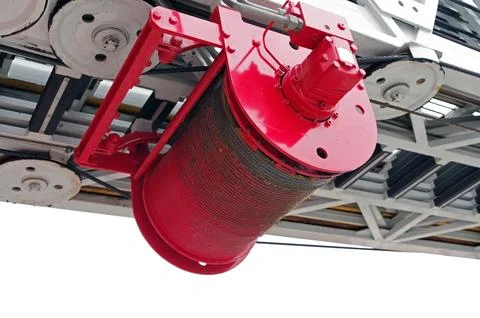 Drum with a cable for lifting stairs on a fire truck Stock Photos