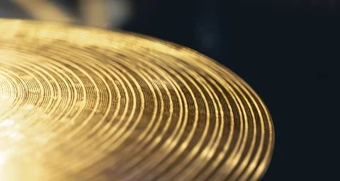 Drum cymbal close-up on a dark background. Stock Photos