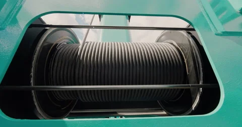 Drum hoist winch. A winch unwinds a steel cable close-up. Hoist drum-winch head. Stock Footage 138024397