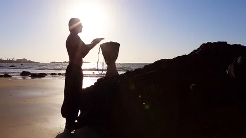 Drum Jembe playing. Drummer. Male Silhouette with Jembe near Sea. Stock Footage