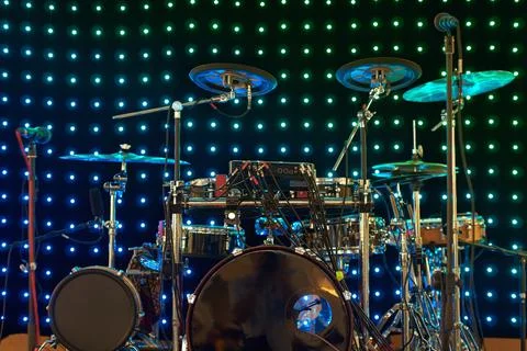 Drum kit with different types of drums on the stage with lights on the Stock Photos