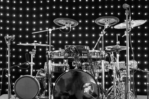 Drum kit with different types of drums on the stage with lights on the Stock Photos