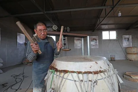 The drum maker is elaborately making cowhide drum, LUANNAN COUNTY, Hebei Pr.. Stock Photos
