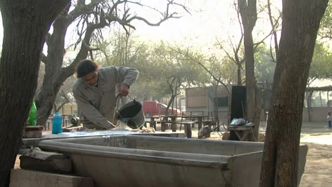 A Drum Maker Wetting Goatskin Membrane while making A Leguero Bass Drum. Stock Footage 218331217