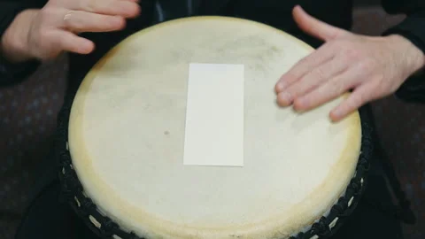 Drum performance scene, fingers tapping vibrant rhythmic patterns on aged Video stock 320910318