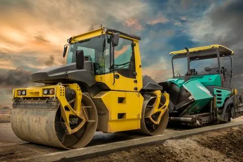 Drum roller and asphalt spreading machine. Stock Photos