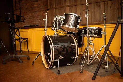Drum set on stage in a recording studio. Musical instruments. Stock Photos
