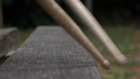 Drum Sticks in slomotion tapping on parkbench Stock Footage 106070729