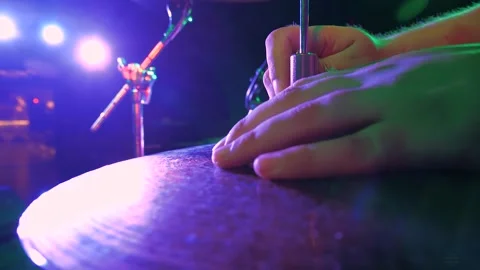 Drummer assembles and tunes the instrument against the backdrop of stage lights. Stock Footage 156785529