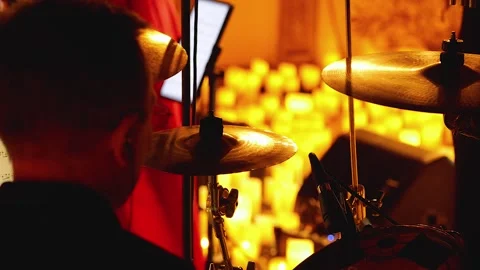 A drummer behind a drum kit with cymbals standing out in the foreground Stock Footage 288178962