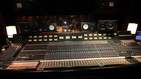 Drummer behind glass pan to engineer at rack of gear Stockbeeldmateriaal 52683442