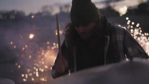 Drummer creates explosive music with fireworks at sunset event party Stock Footage 320018076