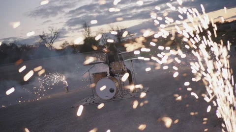Drummer creates stunning fireworks display while playing music outdoors Stock Footage 320017740