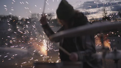 Drummer creating vibrant rhythms alongside dazzling fireworks display Vídeos de archivo 320018457