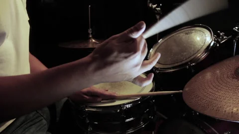 Drummer doing a drumstick twirl in a dark bar Stock Footage 241586419