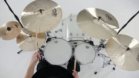 Drummer dressed in black playing white drumset, white background, overhead Stock Footage 142192489