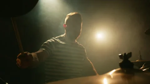 Drummer emotionally plays drums in a dark room full of smoke. Music or song Stock Footage 252709059