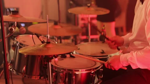 The drummer hits the wet drum. Young man playing drums on stage. The drums and Video stock 196005498